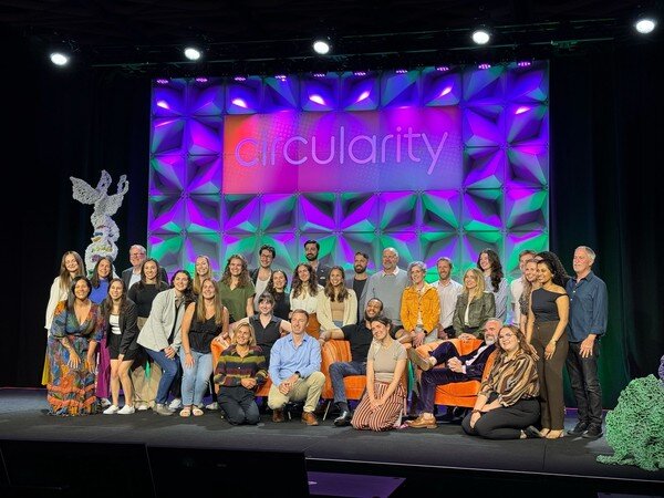 many smiling people posing on the circularity stage