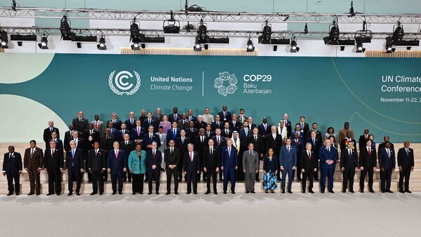  all the numerous COP29 representatives standing on the stage