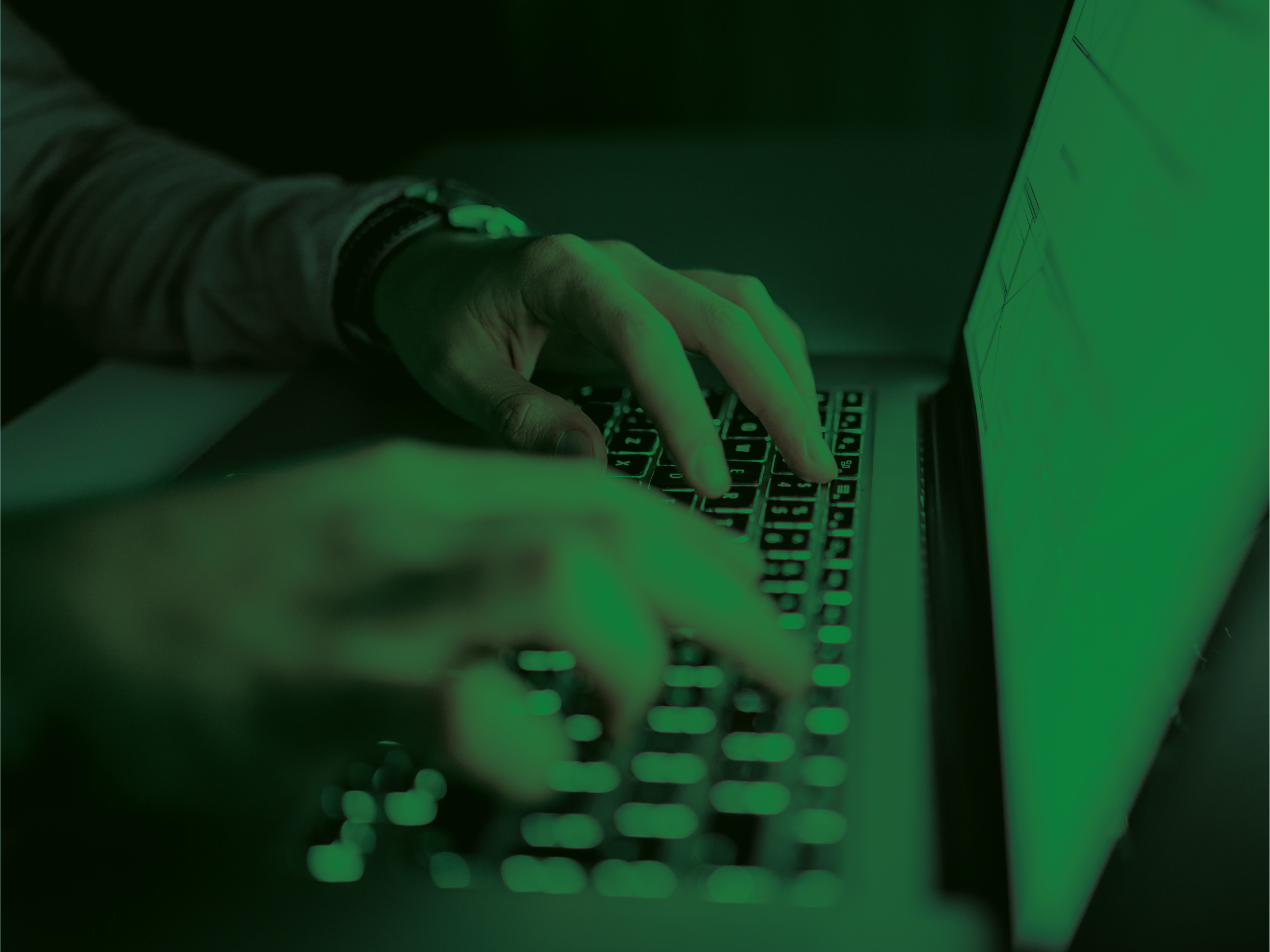 Hands typing on a laptop keyboard